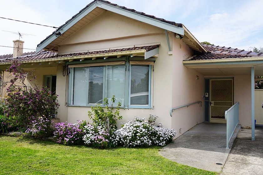 A cottage-style house with flowers under the window.