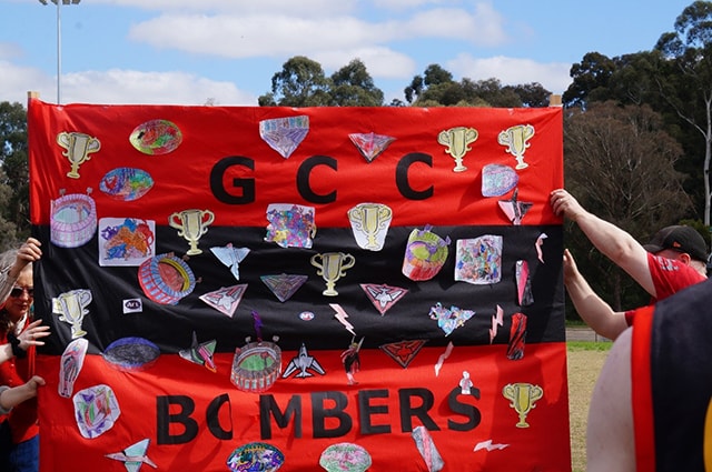 Accord Footy Fever People holding up a GCC Bombers banner