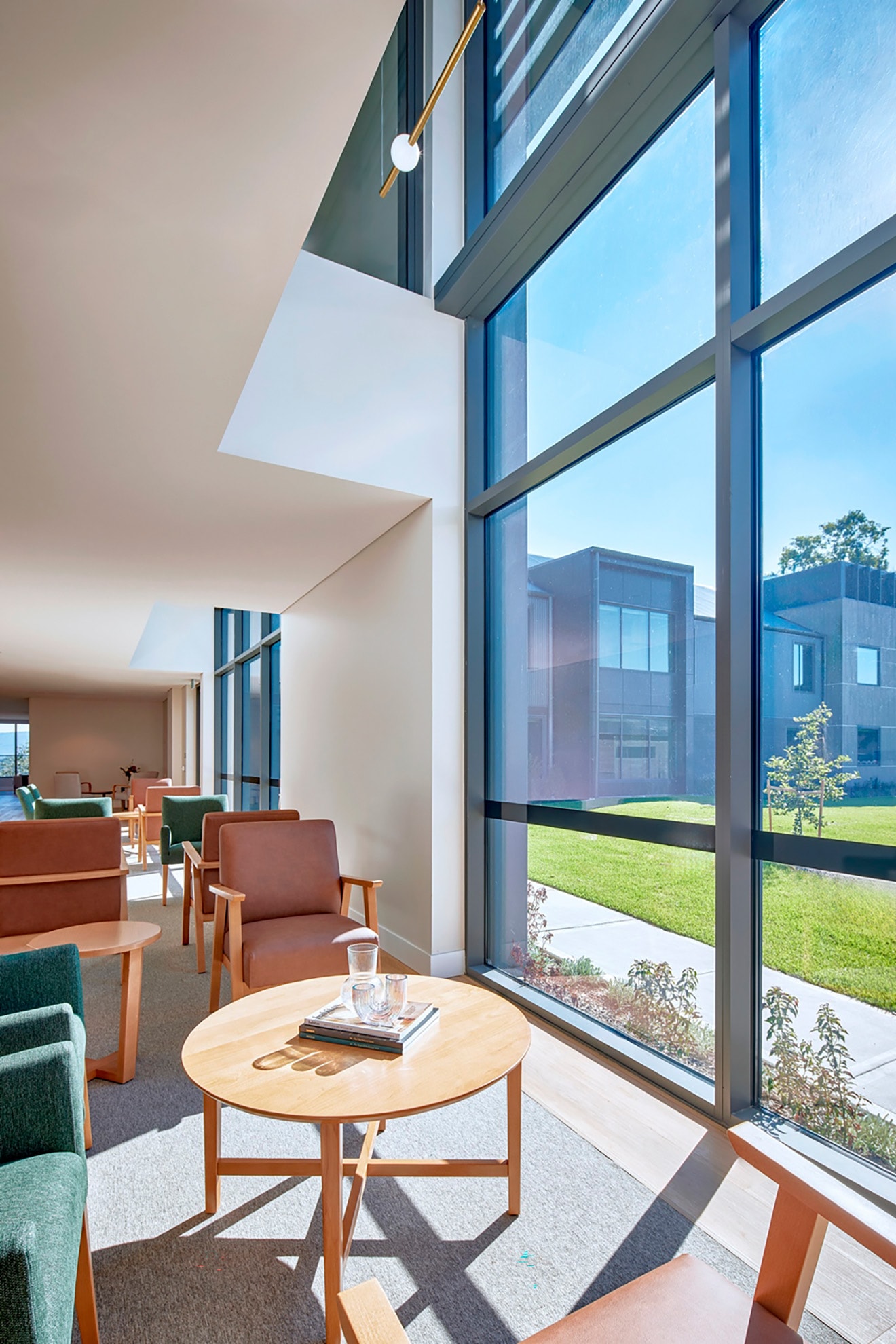 St John of God Richmond Hospital redevelopment interior seating area with full height windows overlooking grass