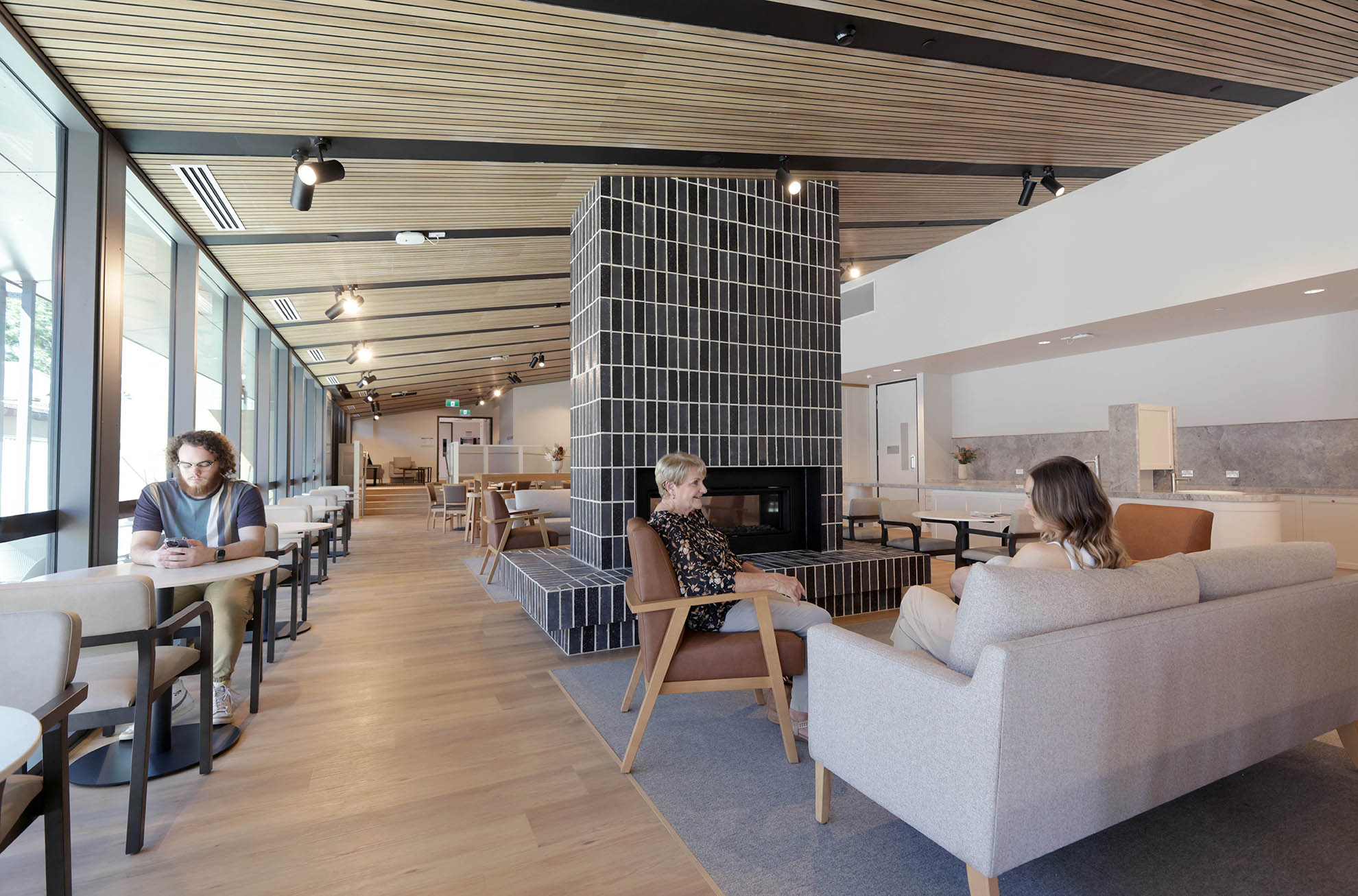 St John of God Richmond Hospital redevelopment dining area with one person seated at table and two people seated on couches