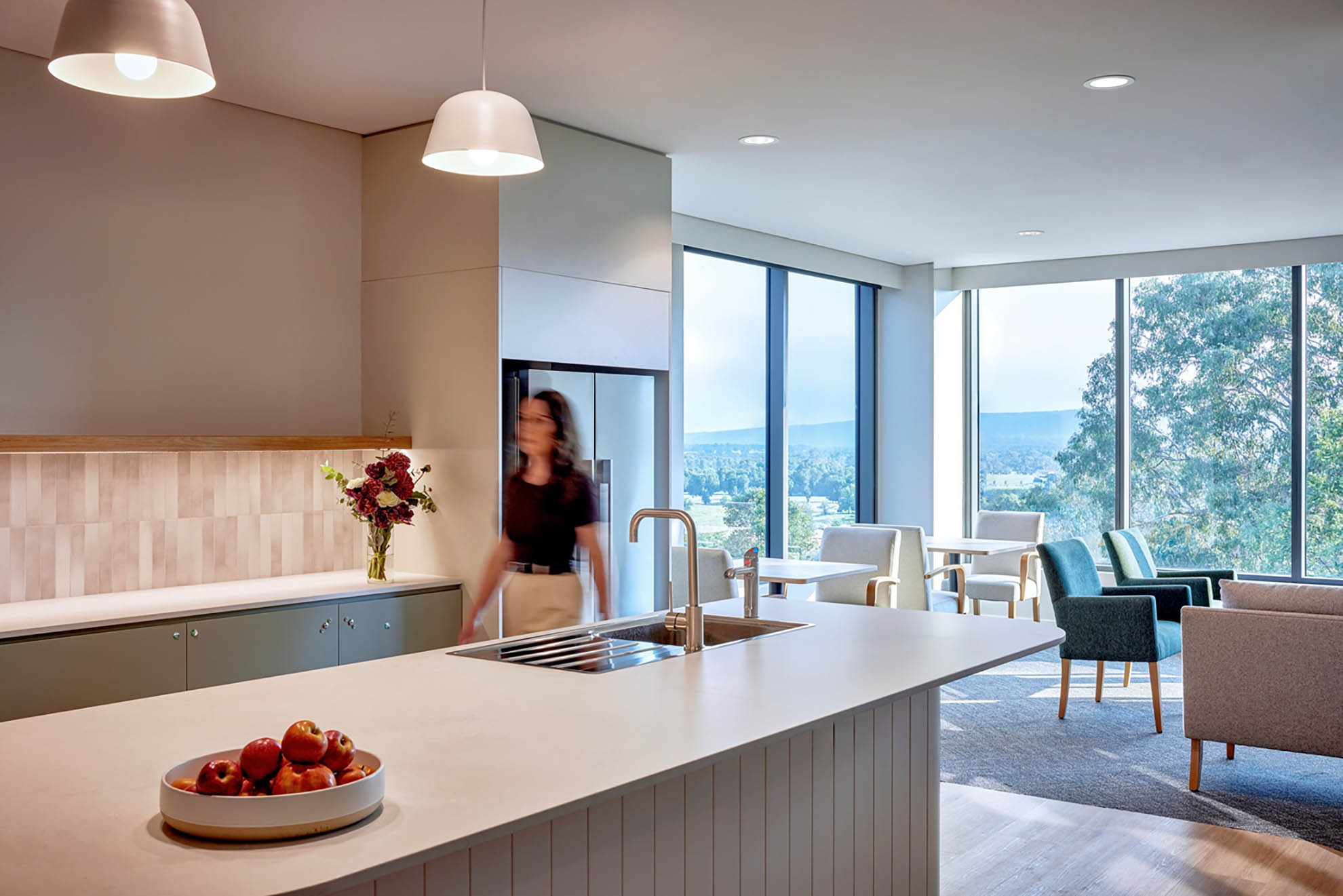 St John of God Richmond Hospital redevelopment young woman walking through kitchen with an island bench
