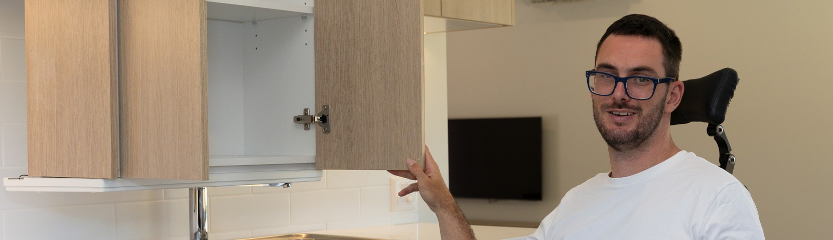 Person opening kitchen cupboard door